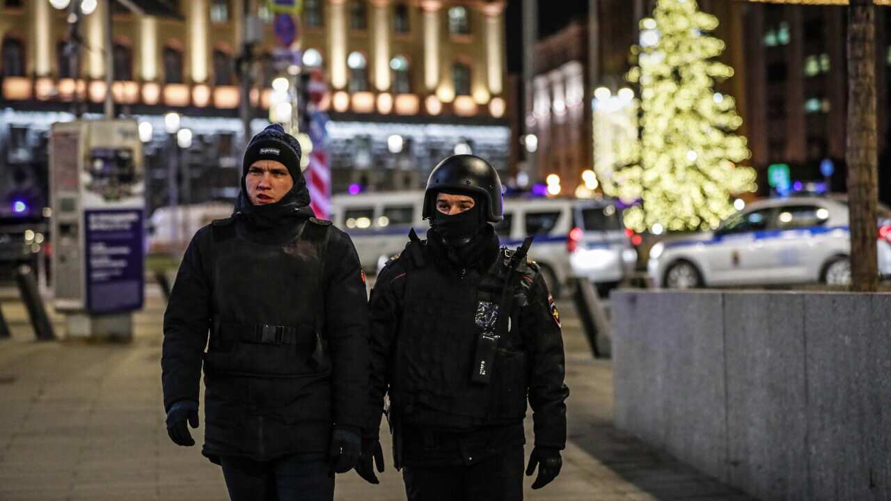 Russian policemen guard in front of the Federal Security Service of the Russian Federation (FSB) headquarters where unknown men opened fire in Moscow.