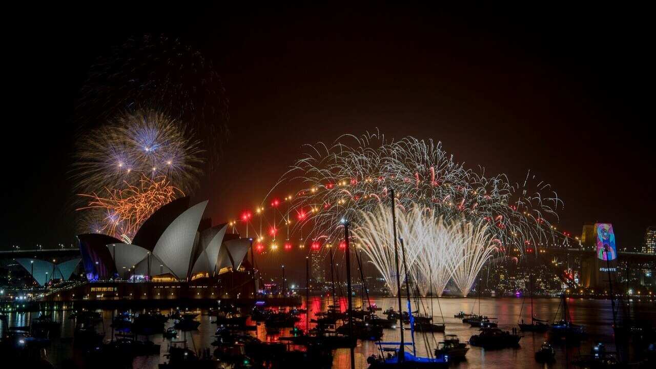 The 9pm fireworks explode over Sydney Harbour.