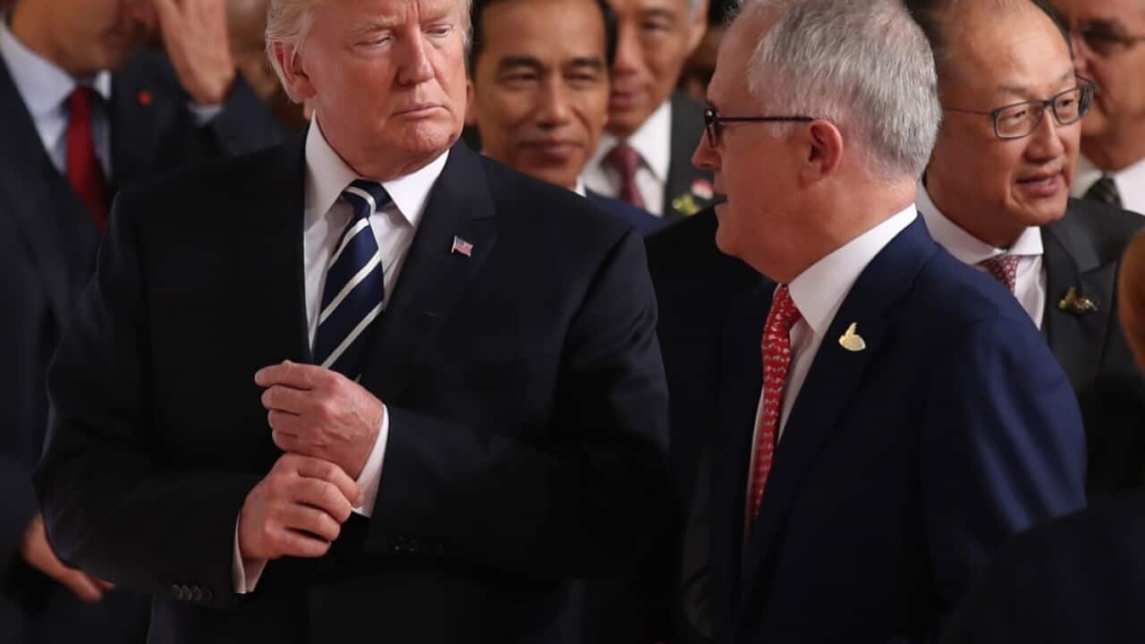 Australian Prime Minister Malcolm Turnbull walks with US President Donald Trump to the family photo during the G20 Summit in Hamburg