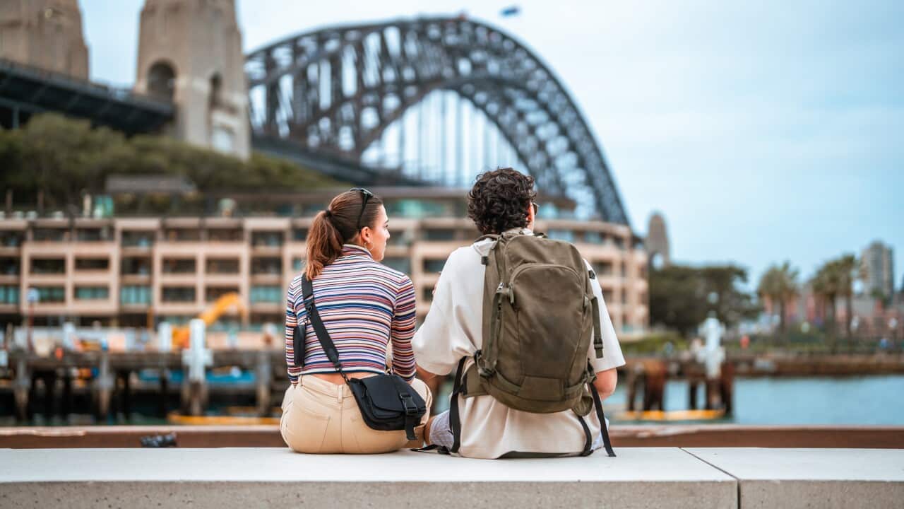 Hispanic Couple Relaxing by Sydney Harbour Bridge During Daytime