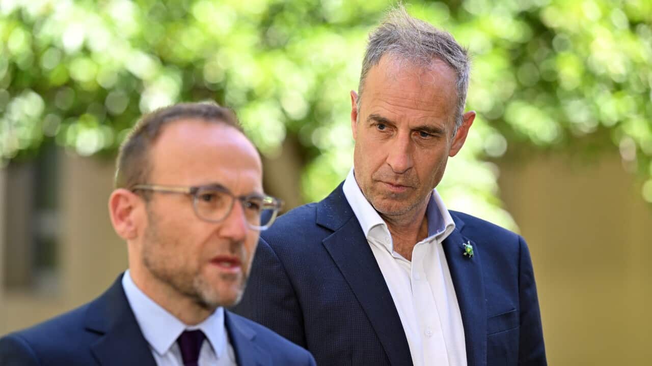 Two men wearing suits