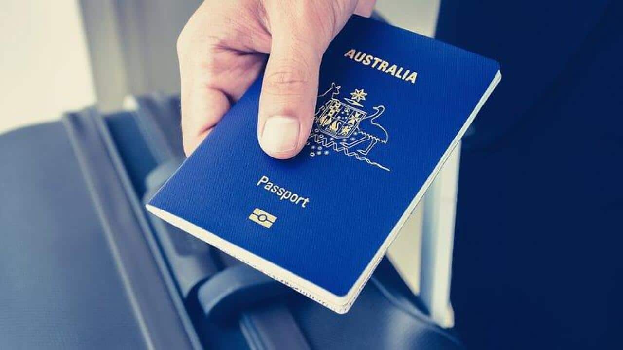 Hands giving Australian passport