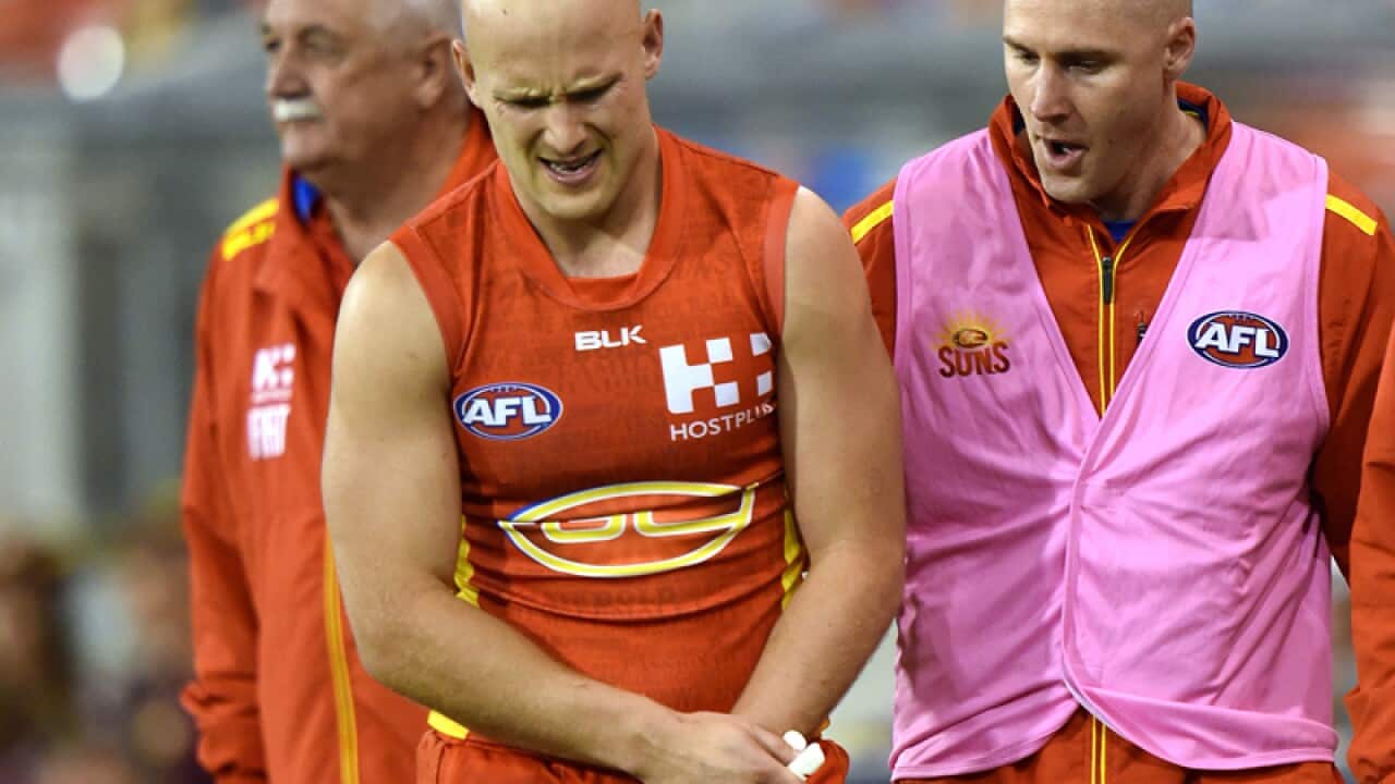 Suns player Gary Ablett is taken from the field