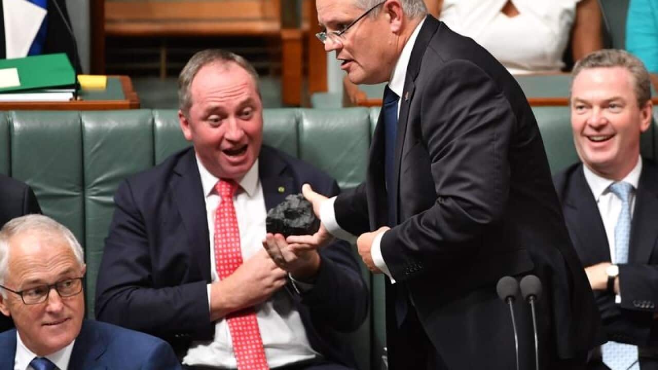 The Treasurer Scott Morrison with a lump of coal in Question Time.