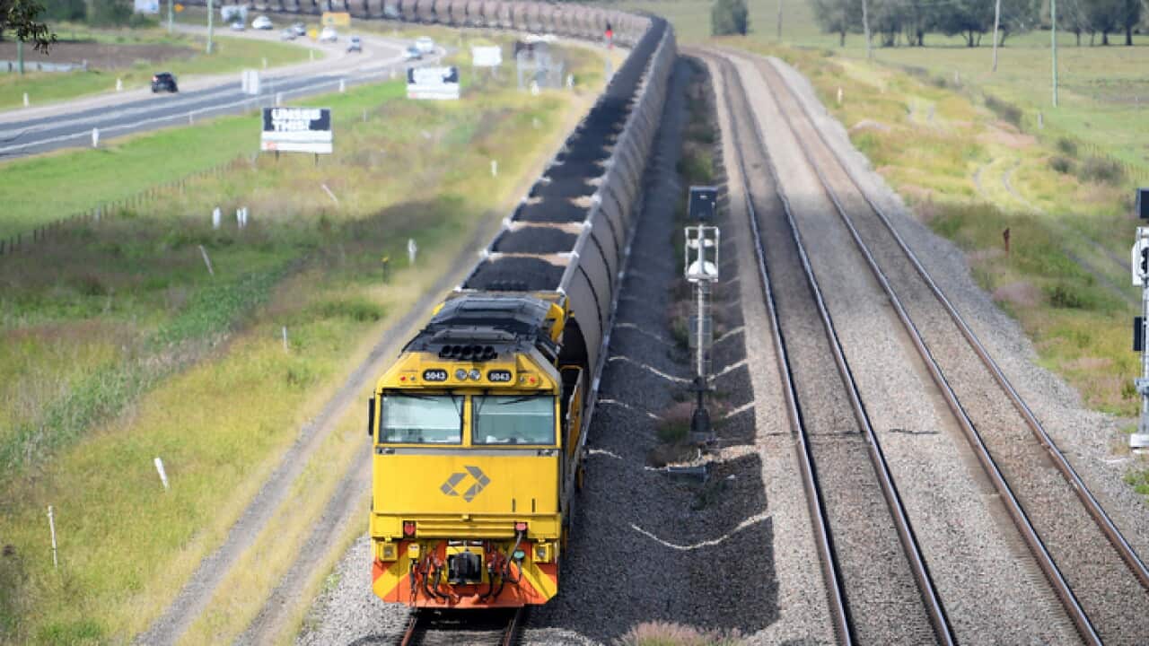 A loaded coal train is seen passing through the outskirts of Singleton, in the NSW Hunter Valley region, on Sunday, April 22, 2018. (AAP Image/Dan Himbrechts) NO ARCHIVING