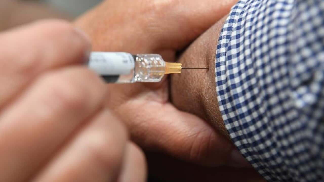 A file image of a man receiving a flu immunisation shot.