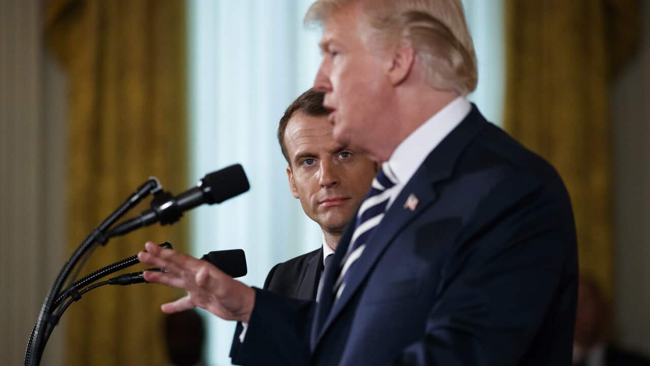 French President Emmanuel Macron listens as President Donald Trump speaks during a news conference in the East Room of the White House, Tuesday, April 24, 2018, in Washington.