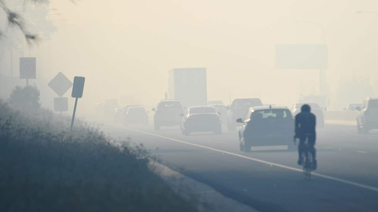 Motorists drive through smoke caused by bushfires on the M5, Sydney, Monday, April 16, 2018.