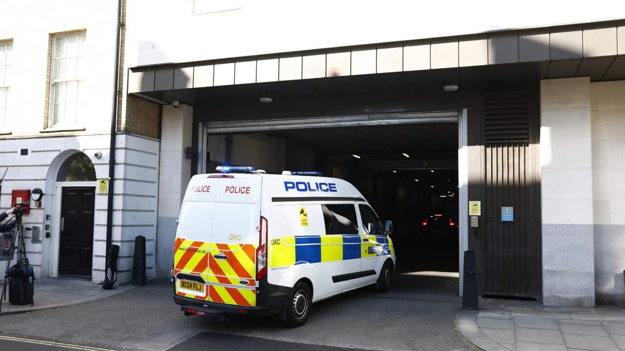 A police van in front of a building entrance