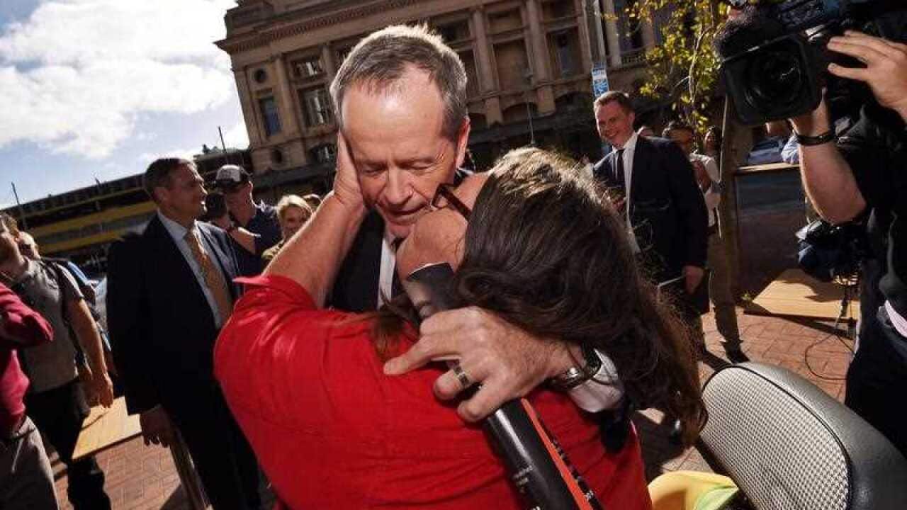 Leader of the Opposition Bill Shorten is kissed by local Margo as part of the 2016 election campaign in Adelaide, Tuesday, May 17, 2016.