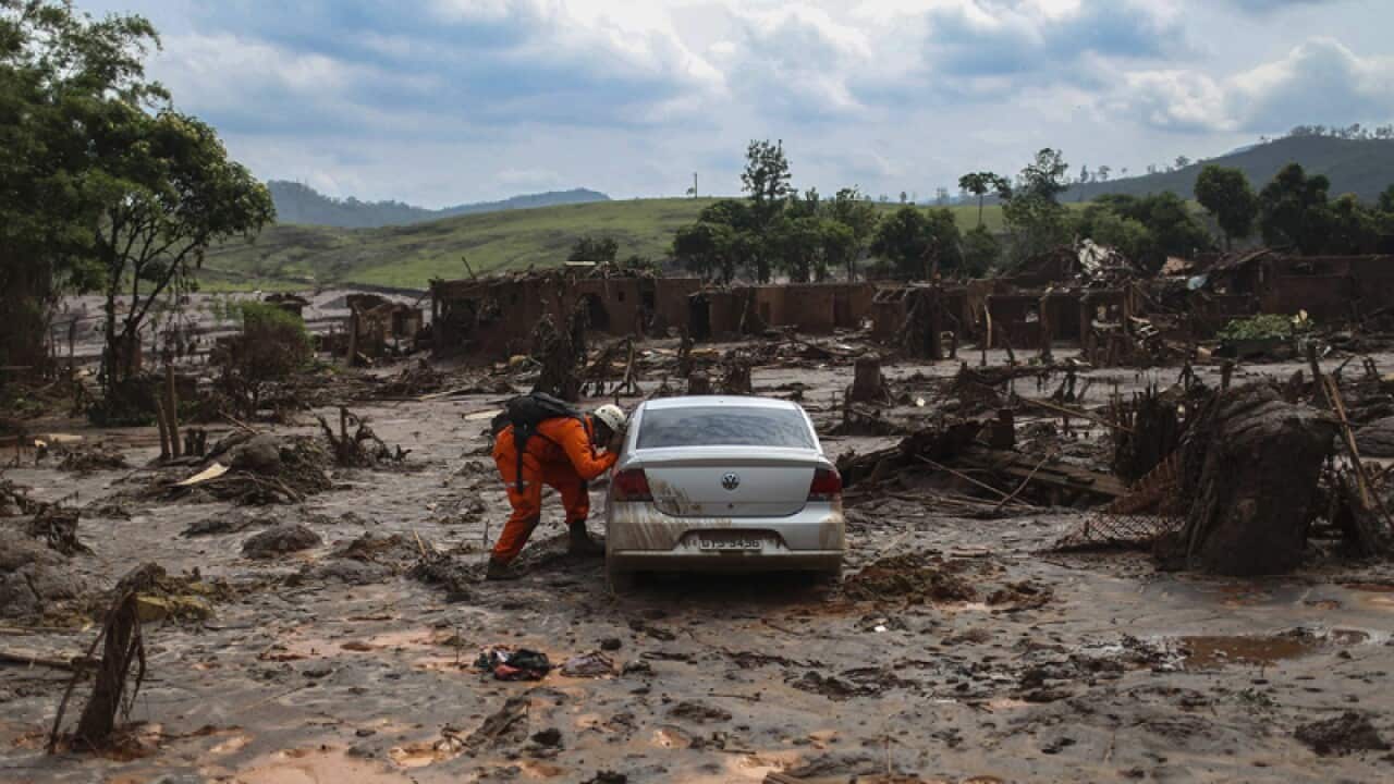 Firefighters search for victims after a Brazilian mining accident