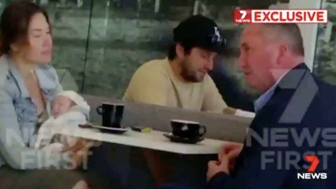 Vikki Campion holds baby Sebastian while Barnaby Joyce looks on. 