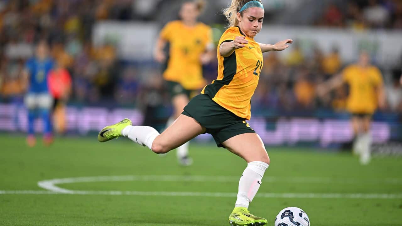 Ellie Carpenter kicking a football in a Matildas game