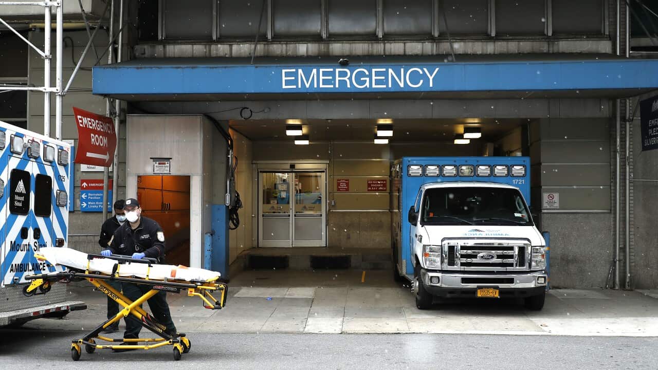 Emergency Medical Technicians move a gurney out of the emergency entrance into an ambulance at Mt. Sinai-Beth Israel Hospital.