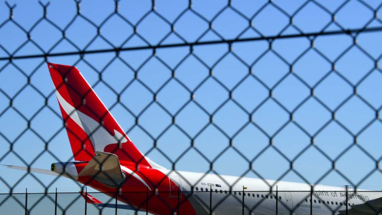 A Qantas plane sits on the tarmac at Sydney Airport in Sydney, Tuesday, August 3, 2021
