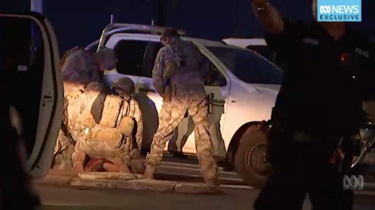 Members of the Territory Response Group(TRG) arrest a suspected gunman in Darwin.