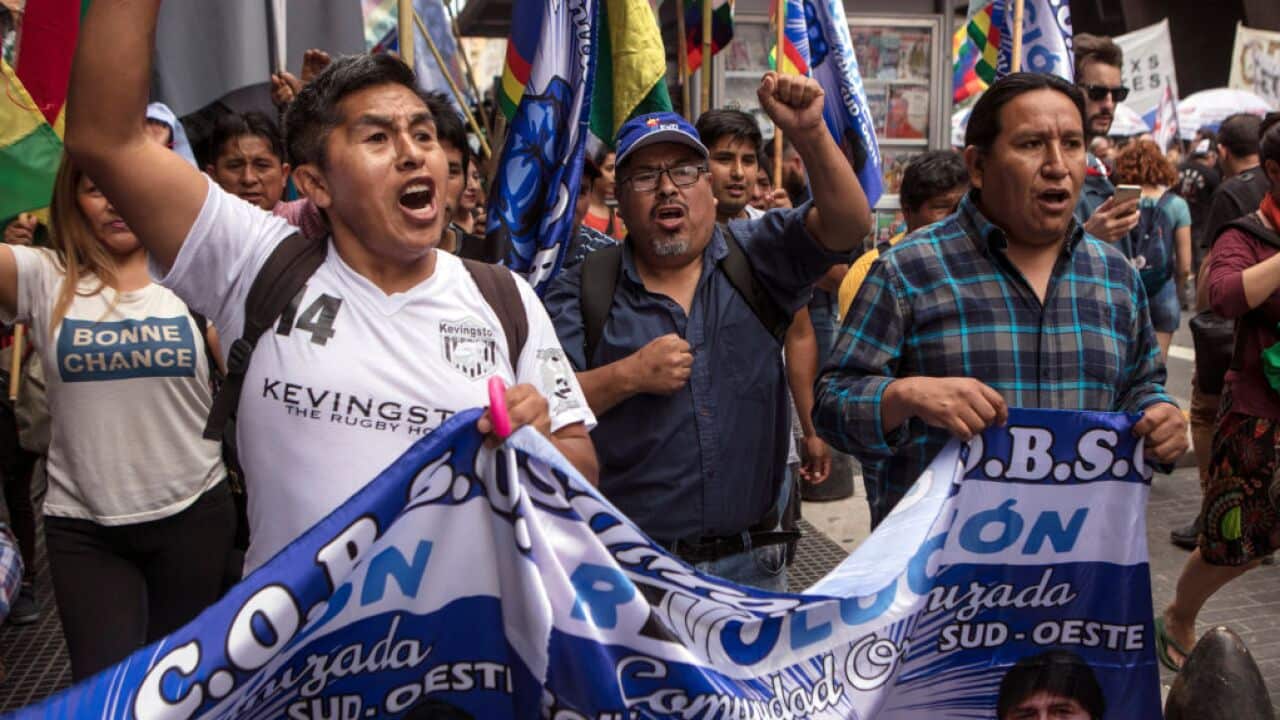 Demonstrators display flags and banners during a demonstration in support of former President of Bolivia Evo Morales