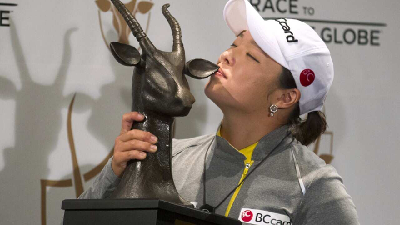 Ha Na Jang kisses the trophy after she won