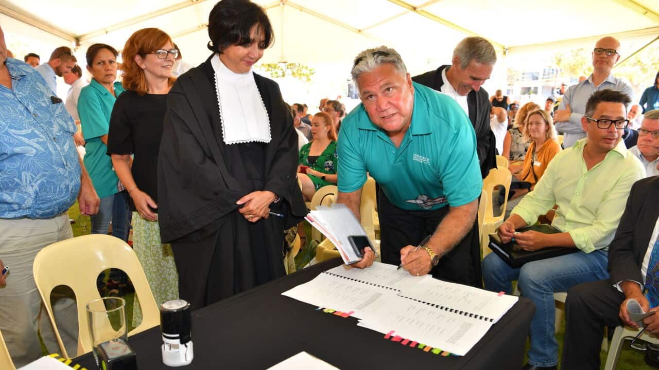 Fred Taylor signing the indigenous land use agreement