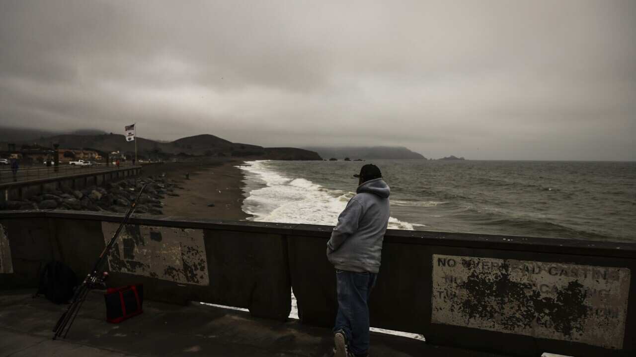 Fisherman looks out at the beach