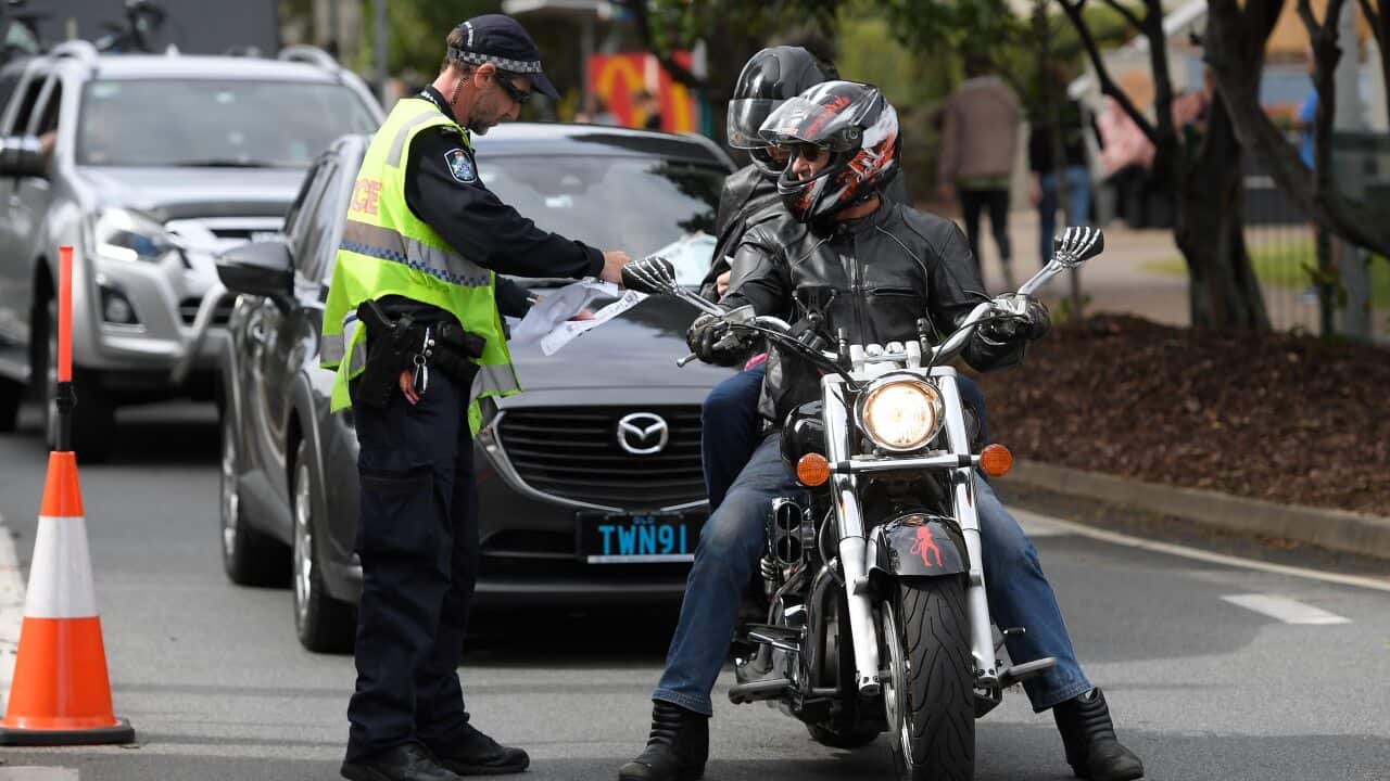 Police stop motorists crossing the Qld-NSW border to check to for permits at Coolangatta on the Gold Coast.