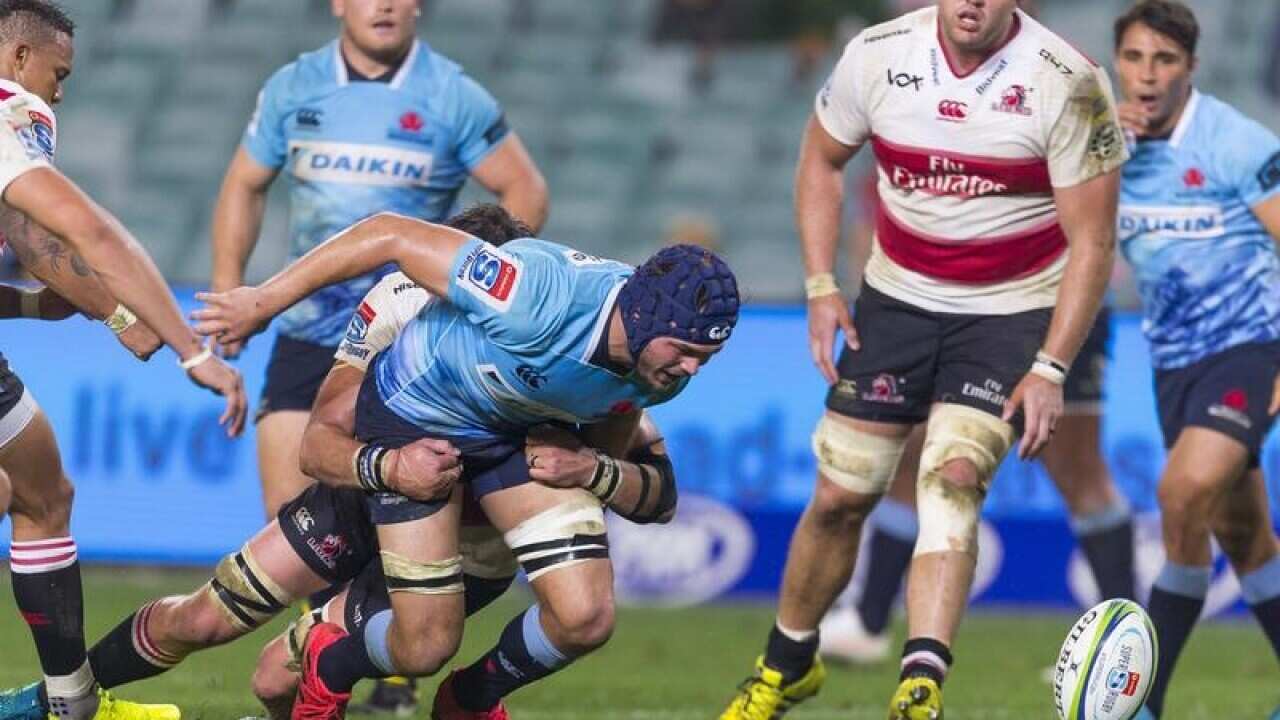 Michael Wells of the Waratahs spills the ball.