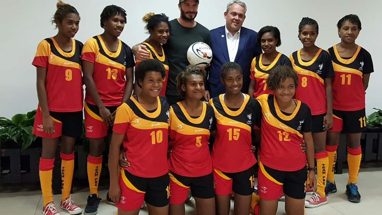 The Papua New Guinea Under 20 women's team with British soccer star David Beckham and PNG Sports Minister Justin Tkatchenko.