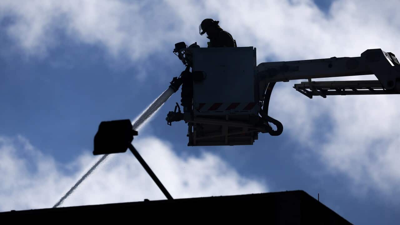 Firefighters at work after a fire at Loafers Lodge in Wellington, NZ