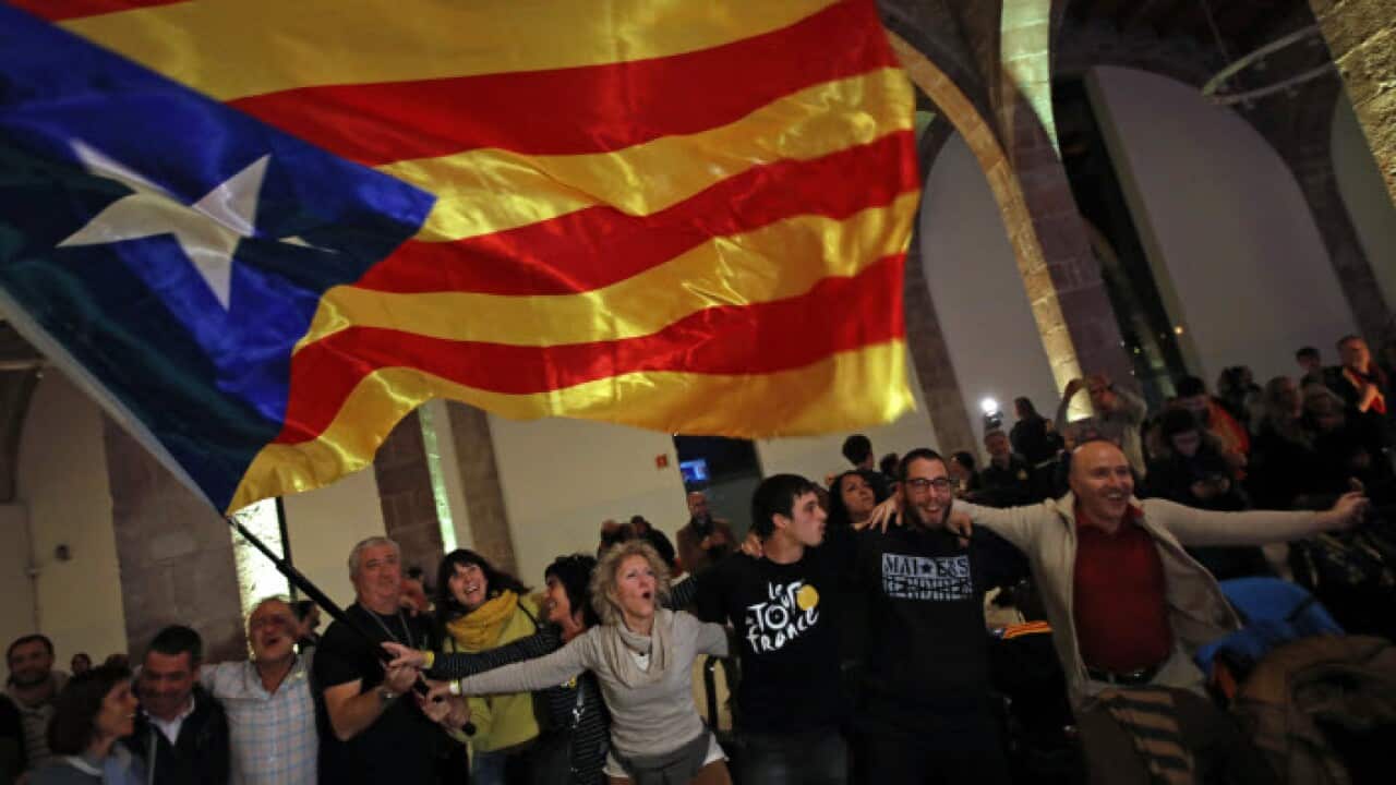 Catalan independence supporters wave a 'estelada' ( pro-independence Catalan flag ) celebrate at the ANC ( Catalan National Assembly ) headquarters after results of the regional elections in Barcelona, Spain