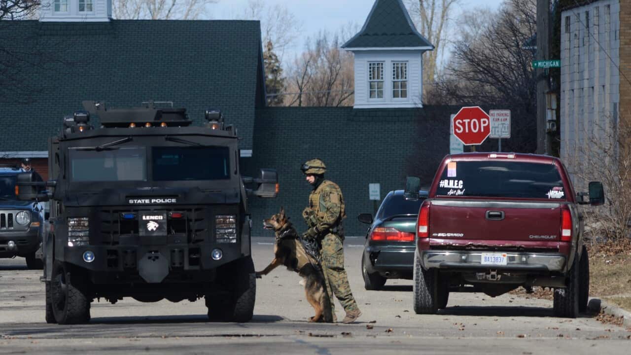 Michigan State Police along with FBI and ATF agents canvas neighbourhoods in Mt Pleasant.