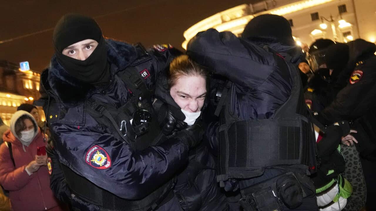 Police officers detain a demonstrator in St. Petersburg