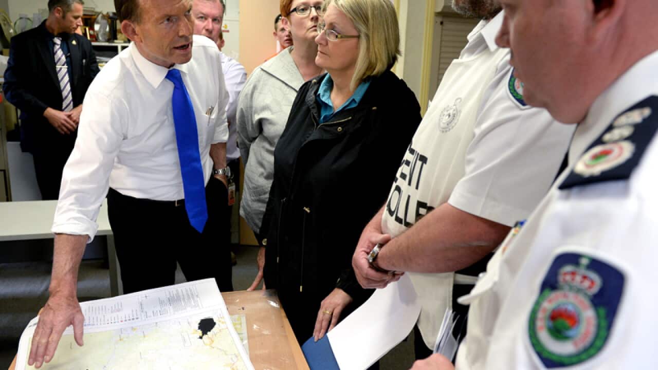 Prime Minister Tony Abbott (L) is briefed on bushfires at Winmalee