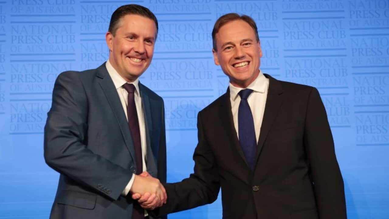 Shadow Minister for Environment, Climate Change and Water Mark Butler and Minister for the Environment Greg Hunt shake hands prior to the Environment Debate
