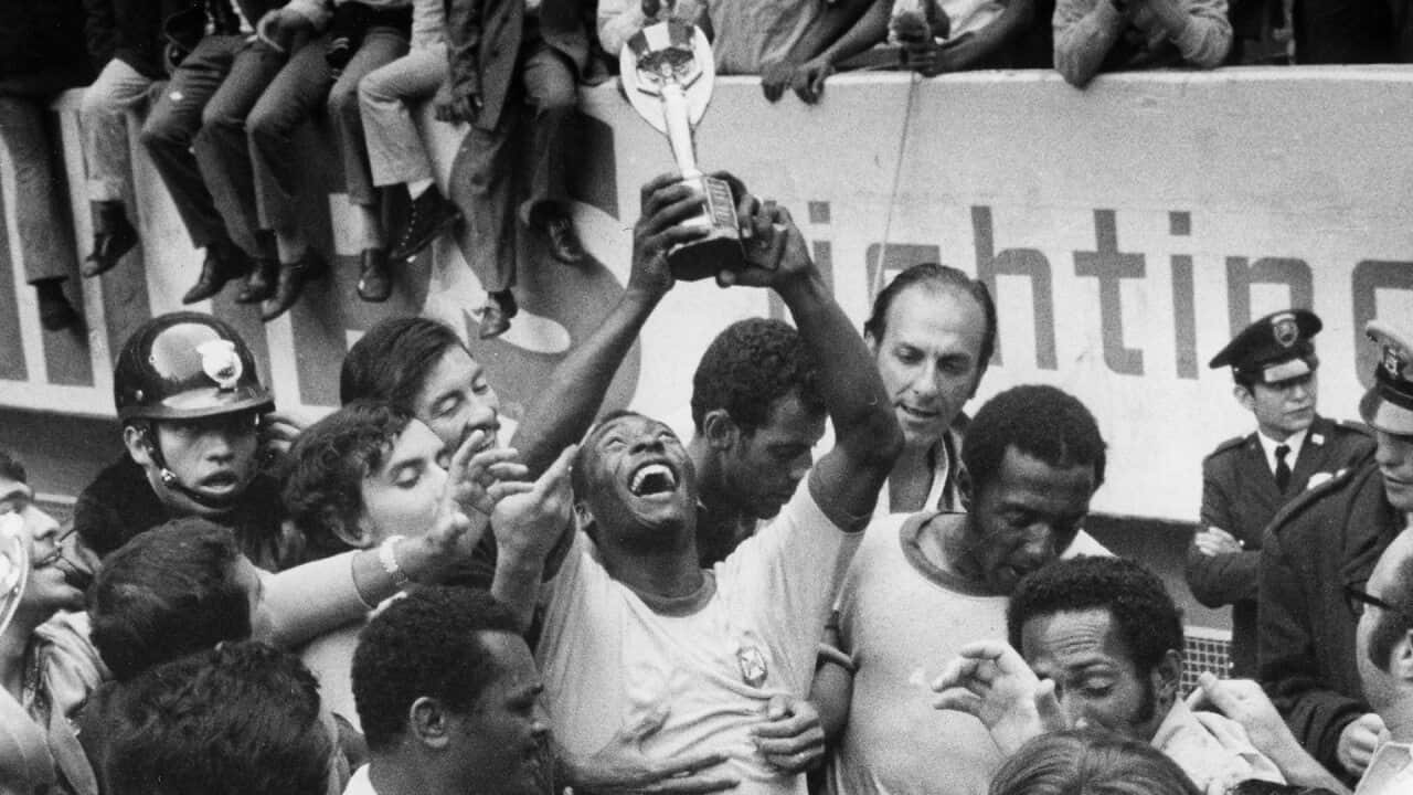 Pele lifts the 1970 FIFA World Cup trophy aloft