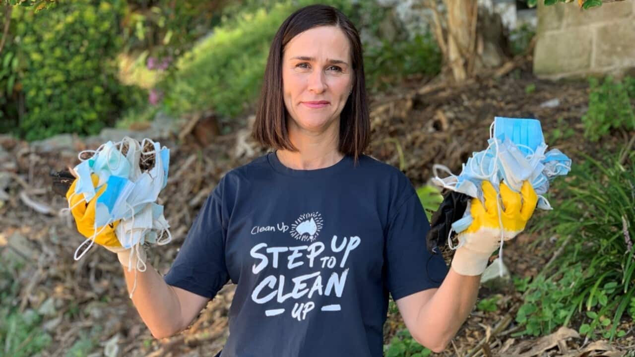 Clean Up Australia chairwoman Pip Kiernan holding up face masks found during a litter collection. Credit: PR Handout. Image Source: CLEAN UP AUSTRALIA