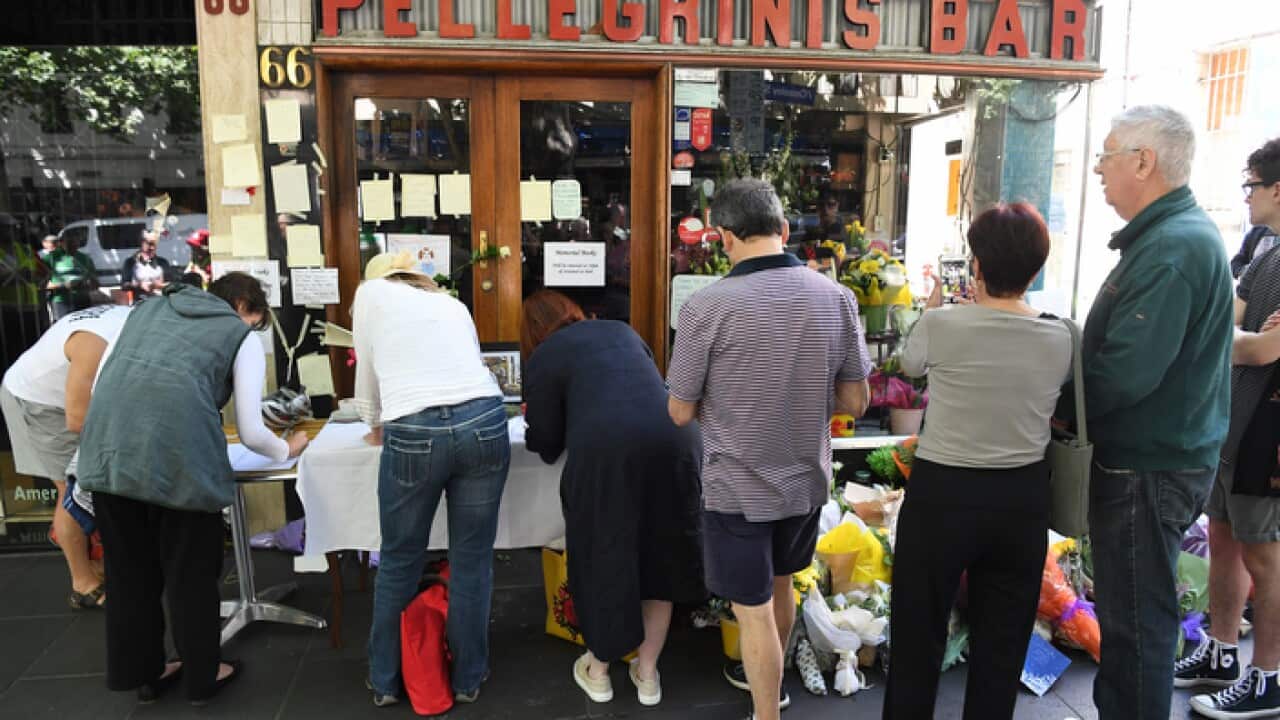 Mourners pay their respects at the workplace of the man killed at Bourke Street