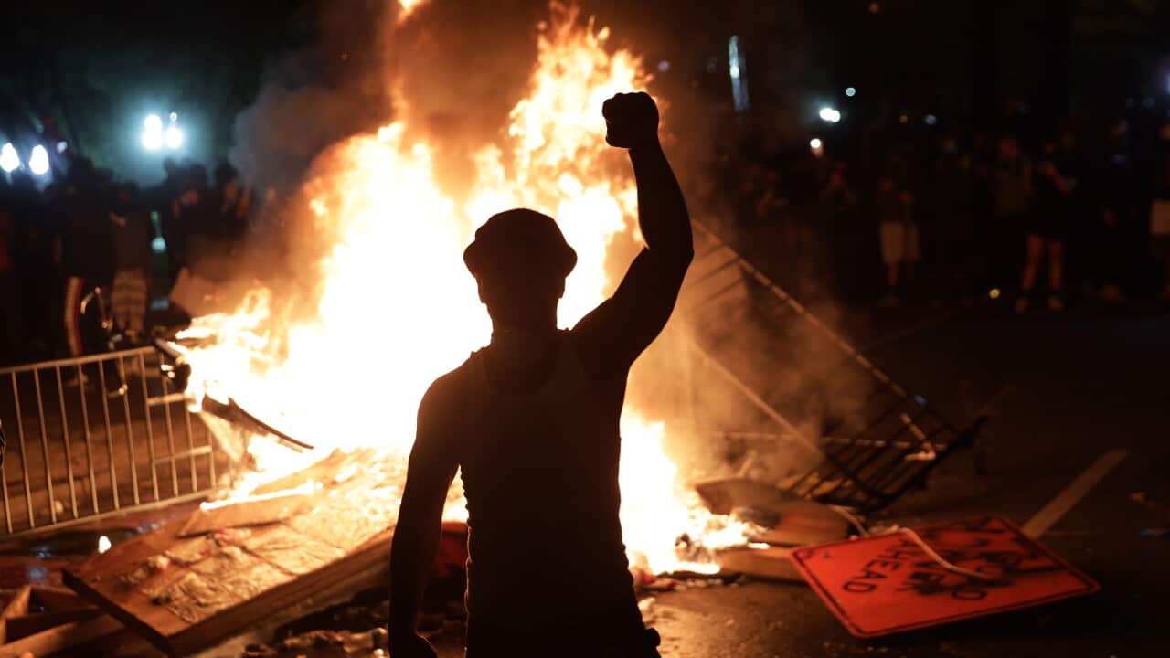 Demonstrators set a fire during a protest near the White House in Washington DC.