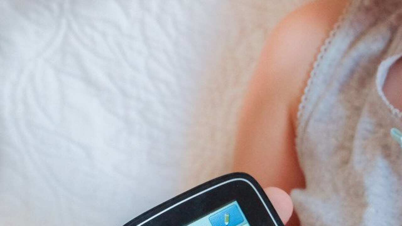 A child checks her blood sugar.