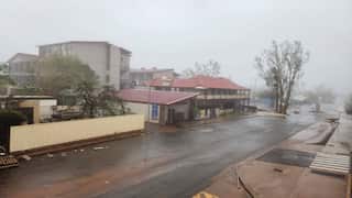 A rain-battered town in Western Australia is lashed by high winds and heavy rain from Tropical Cyclone Narelle. The town street depicted is deserted and covered in debris.