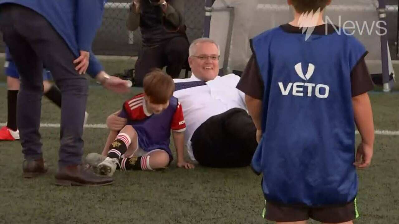 PM accidentally tackles child during soccer media event