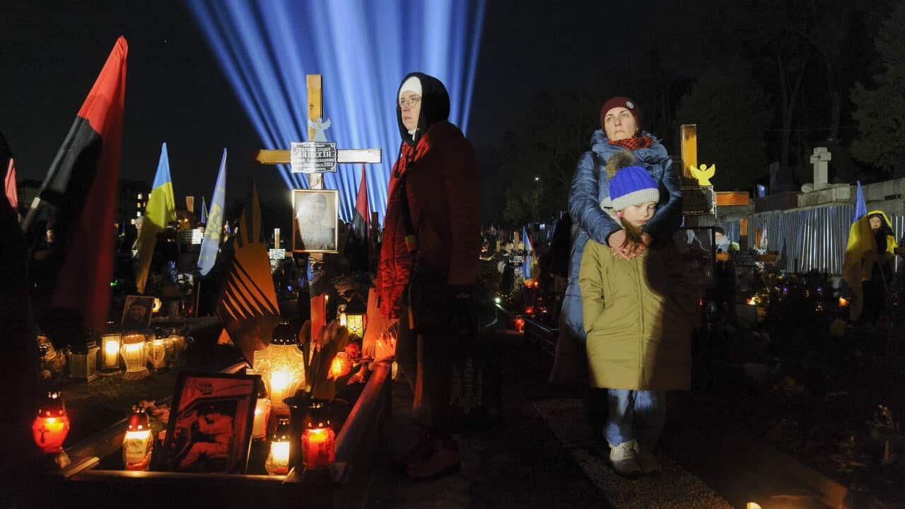 A vigil is held at Lychakiv military cemetery in Lviv to mark the first anniversary of the conflict.