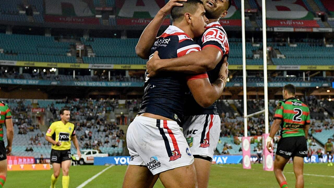 Latrell Mitchell of the Roosters, (left), celebrates with Daniel Tupou