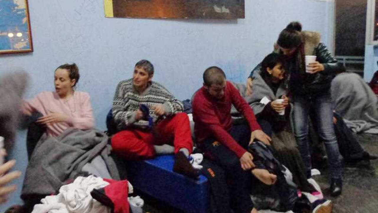 Survivors change clothes at Kalymnos island after a rescue operation by the coast guard Friday.