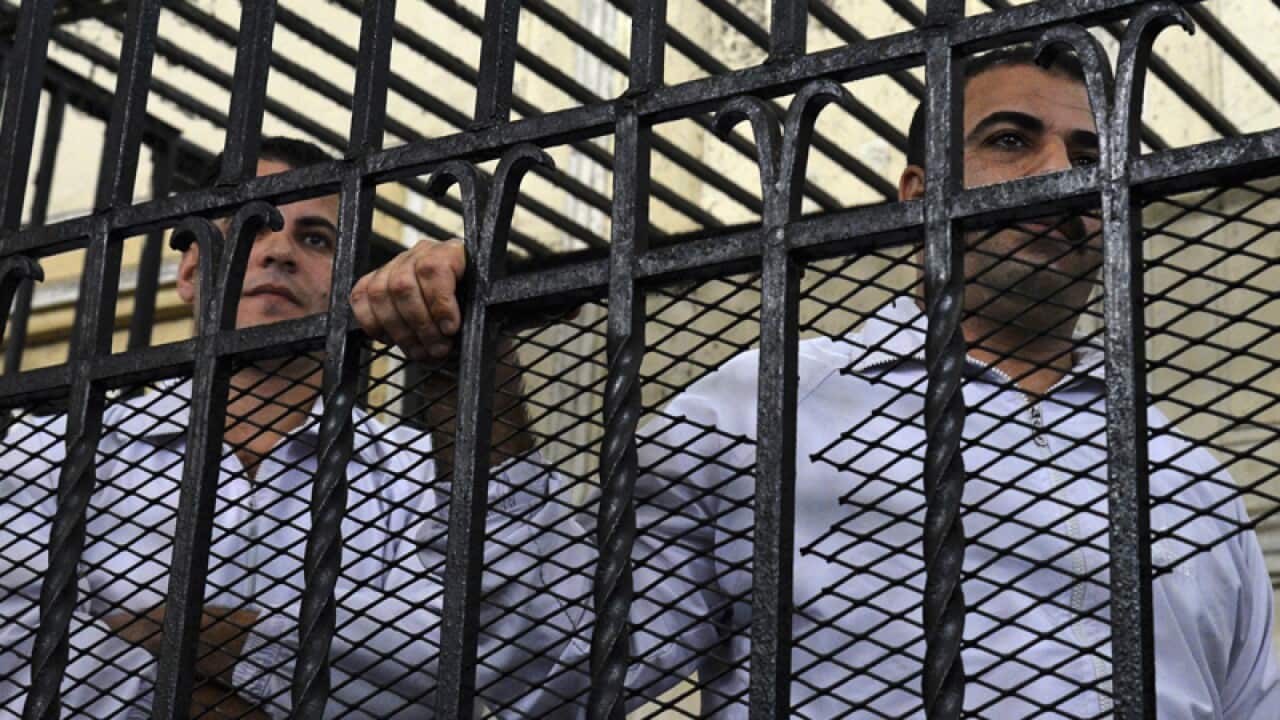 jailed policemen Awad Suliman, right, and Mahmoud Salah