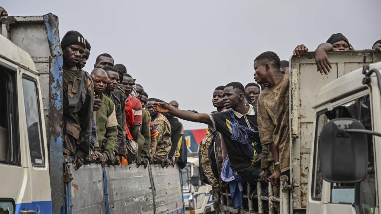 M23 rebels escort government soldiers and police who surrendered to an undisclosed location in Goma, Democratic republic of the Congo (AAP).