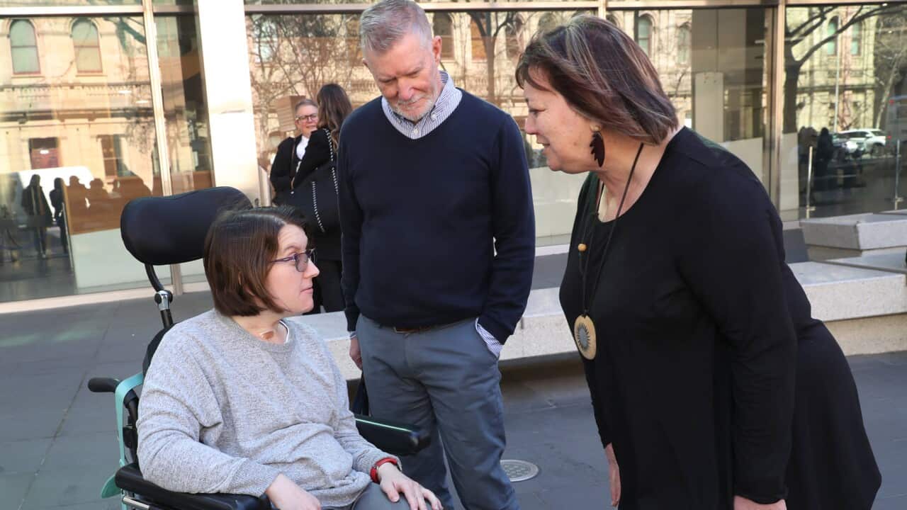 A woman and her parents outside a Royal Commission hearing
