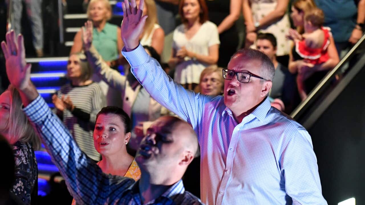 Prime Minister Scott Morrison and wife Jenny sing during an Easter Sunday service at his Horizon Church at Sutherland in Sydney, Sunday, April 21, 2019. (AAP Image/Mick Tsikas) NO ARCHIVING