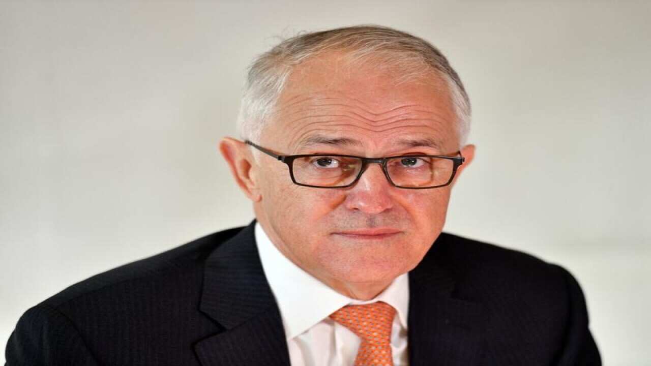 Malcolm Turnbull looks on