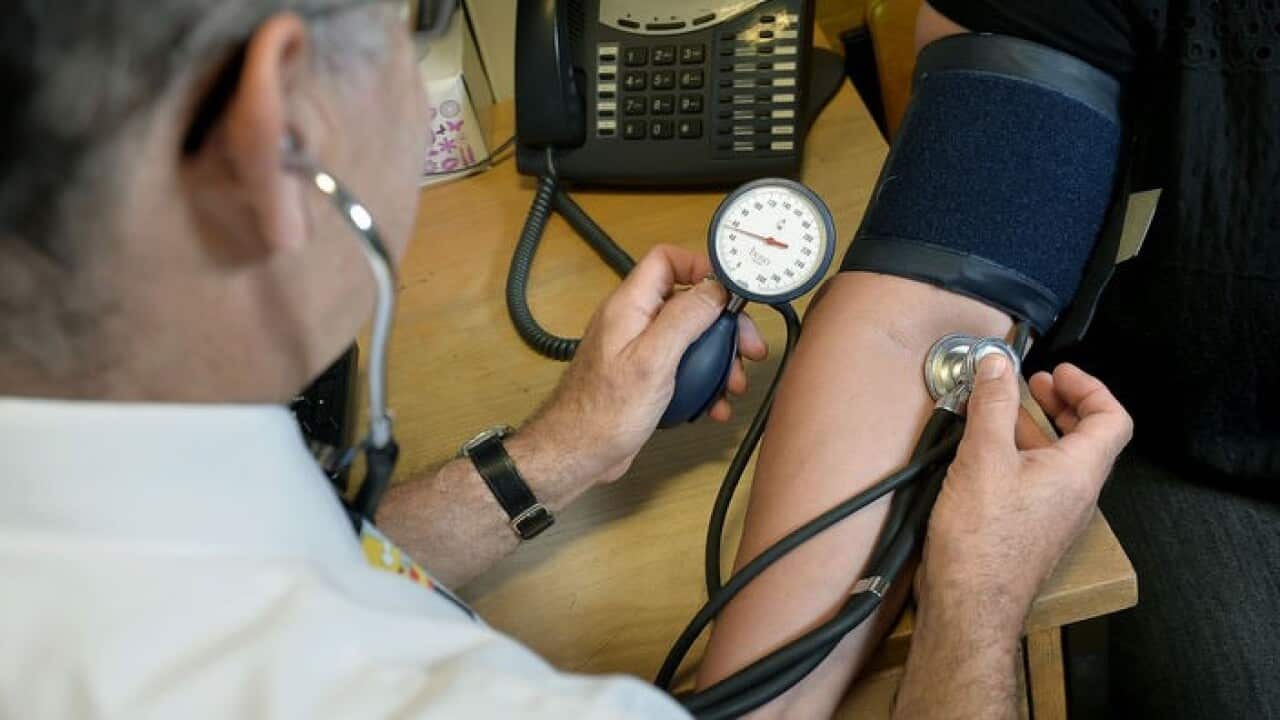 A GP is checking a patient's blood pressure