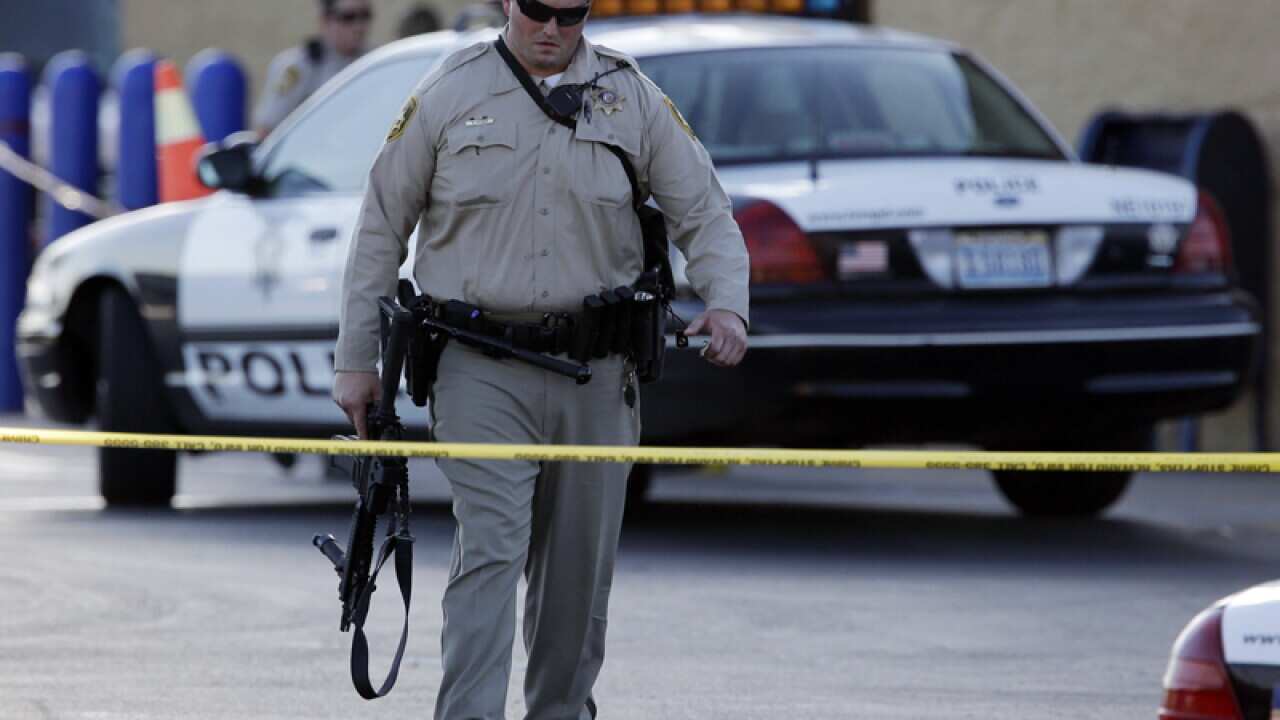 A Las Vegas police officer walks away from the scene of a shooting